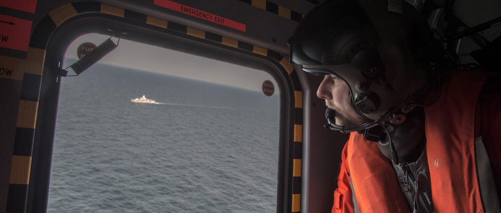 Helikopter 14F genomför spaning i utbåtsjaktområdet. En visbykorvett som deltar i övningen syns i bakgrunden. Helikopter 14 F är försedd med en doppsonar som gör att helikoptern har en förmåga att snabbt söka av ett större geografiskt område efter ubåt. 