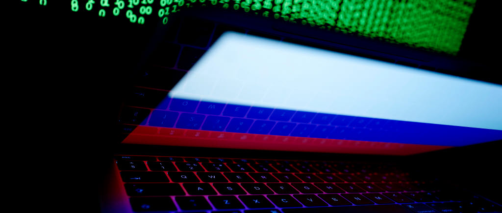 FILE PHOTO: A Russian flag is seen on the laptop screen in front of a computer screen on which cyber code is displayed, in this illustration picture taken March 2, 2018. REUTERS/Kacper Pempel/Illustration/File Photo  X02307