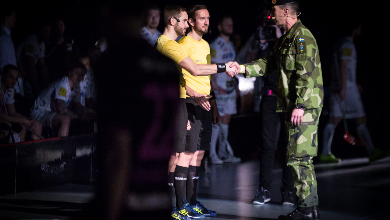 SM-finalerna i innebandy 2017. ÖB Micael Bydén lämnar över matchbollen till majoren och herrfinaldomaren Rickard Wissman.