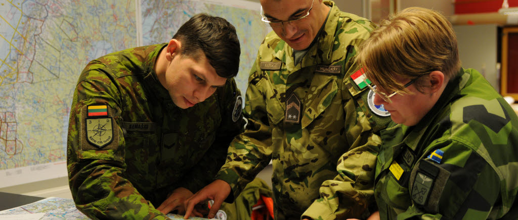 Sergejus Semasko (Litauen), Erno Fazekas (Ungern) och Carina Wiklund (Sverige) diskuterar övningsförutsättningar i stridsledningen på F 21 under övningen Trident Juncture 18.