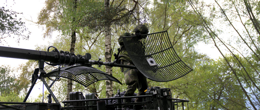 Soldat med radar ovanpå bandvagn
