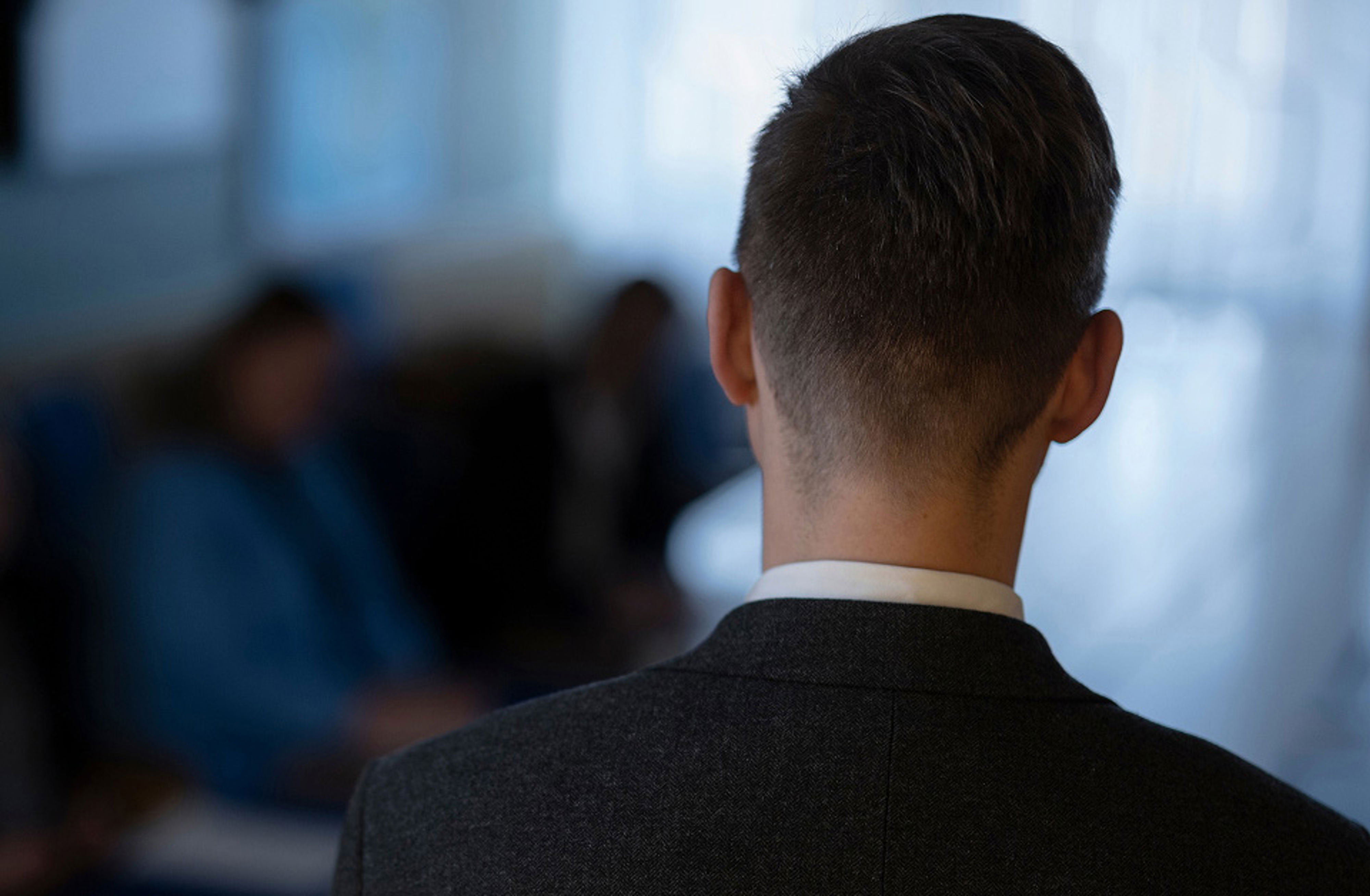 man i kostym bakifrån