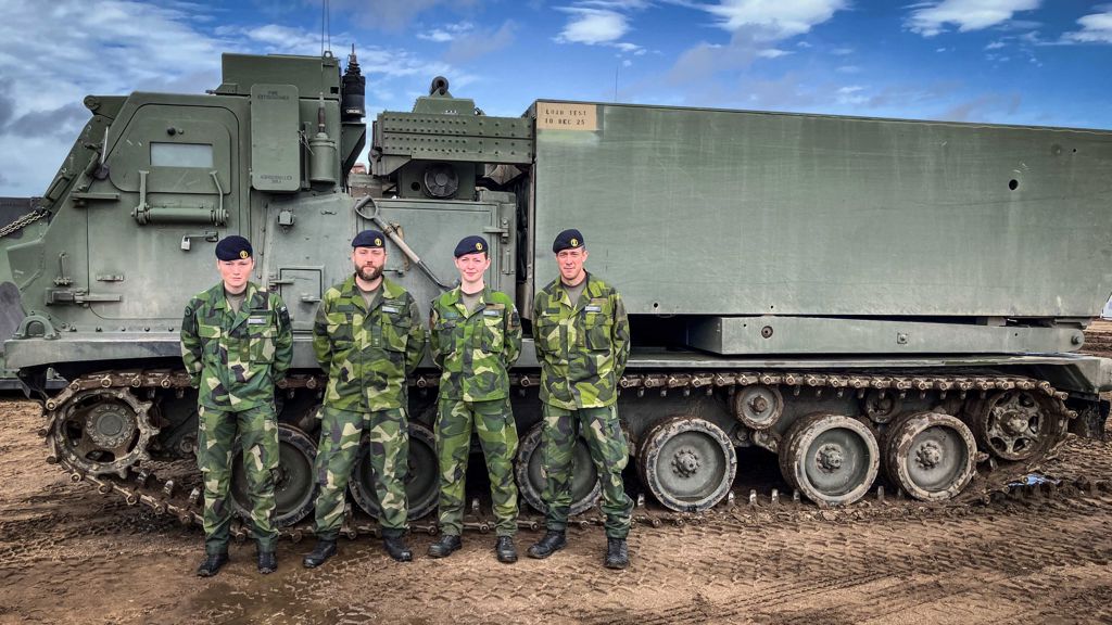 Den svenska delegationen framför ett MLRS-system.
