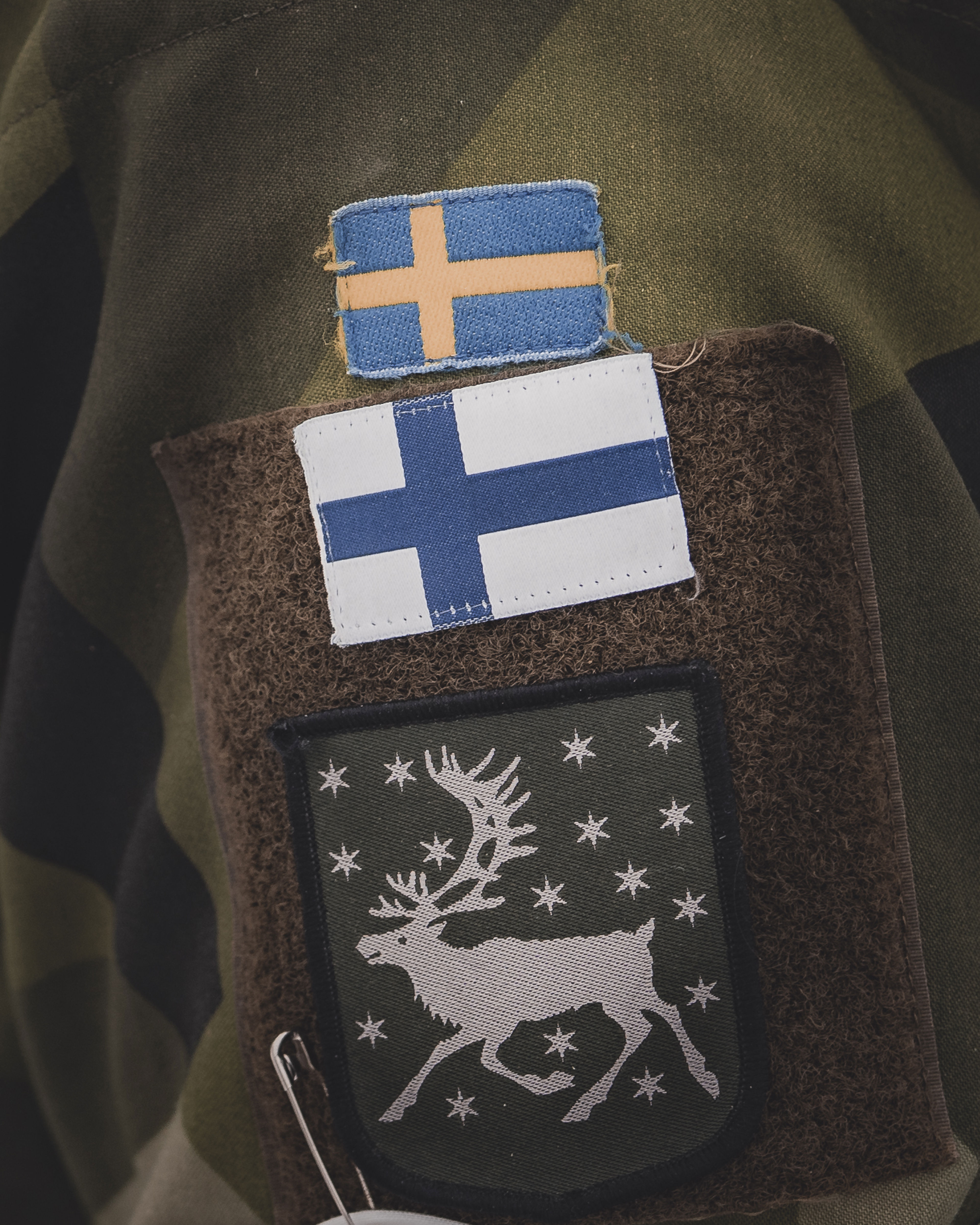 Finland's and Sweden's flags next to each other on a uniform. 